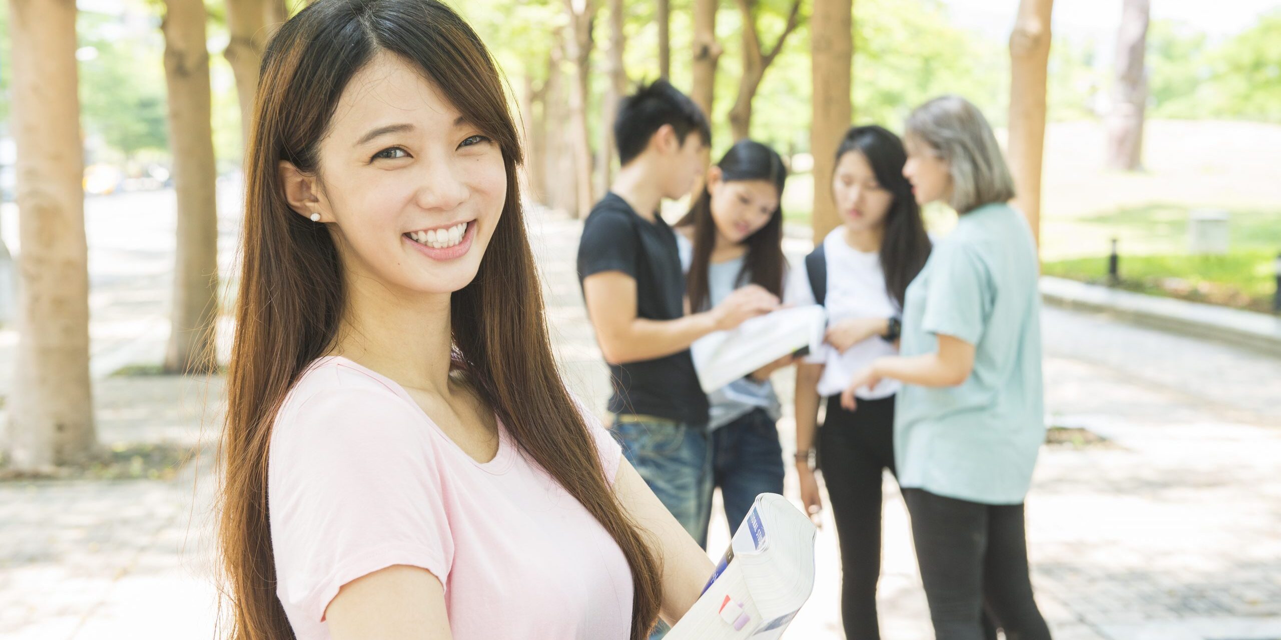 group of happy teen high school students outdoors